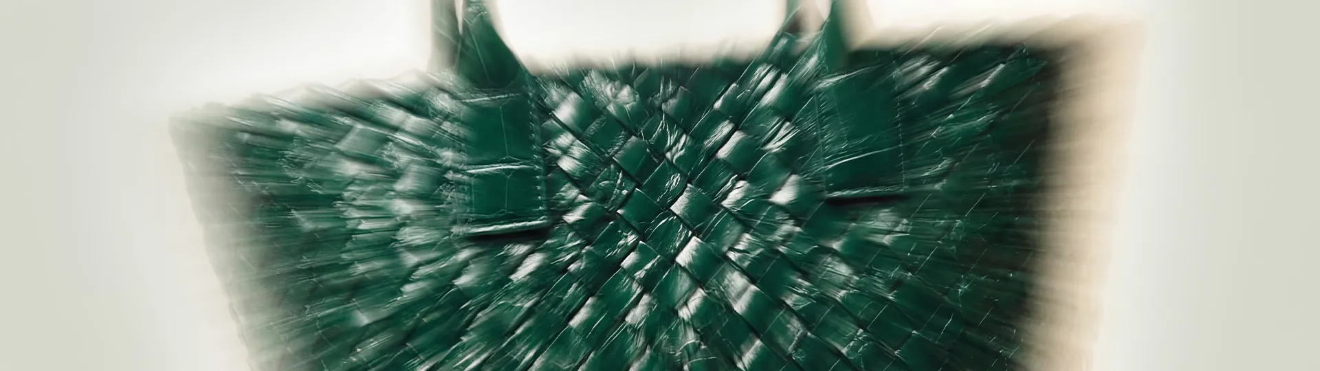 Blurred Bottega Veneta woven leather bag showcasing signature craftsmanship